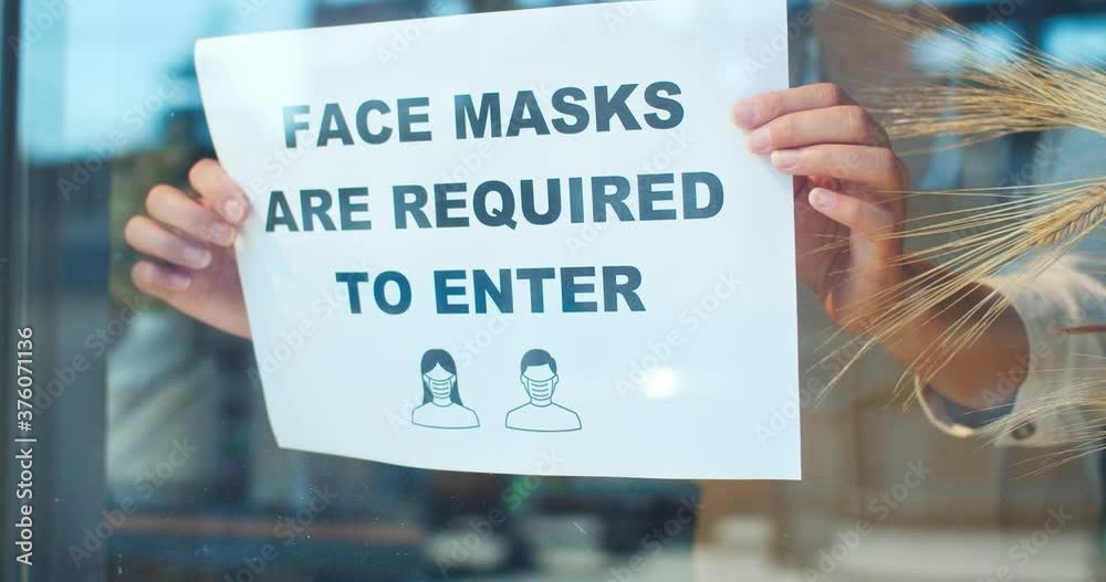custom made wallpaper toronto digitalOutdoor view of flower store window during pandemic period. Protected female florist attaching paper with text "face masks are requiered to enter". Quarantine safety measures, covid-19.