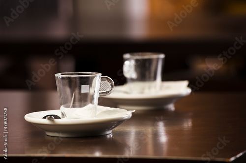 coffee cups, above the wooden table, inside the cafeteria and free space for decoration.