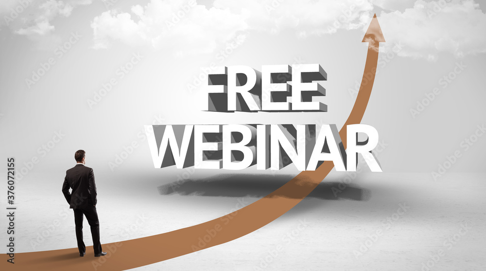 Rear view of a businessman standing in front of FREE WEBINAR inscription, successful business concept Rear view of a businessman standing in front of FREE WEBINAR inscription, successful business concept