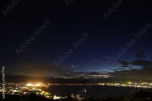 A wide shot looking out over the Lake and the city in Japan during a summer sunset.