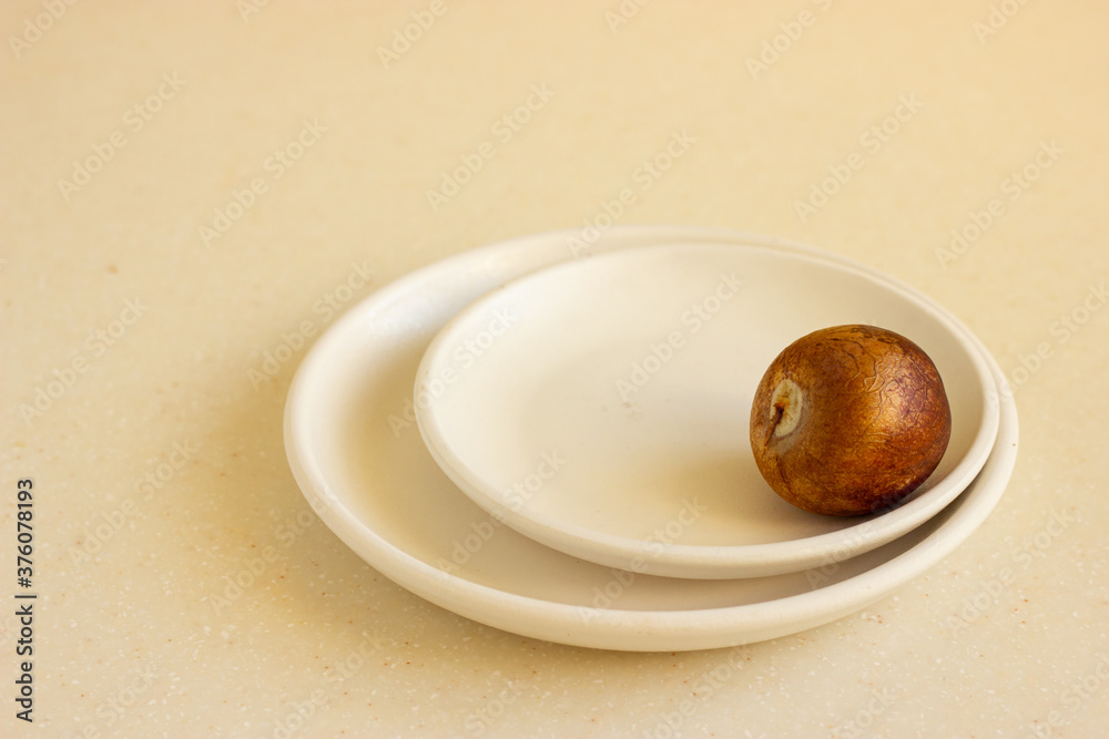Bone from the avocado or avocado seed on beige ceramic plates. Bone from the avocado or avocado seed on beige ceramic plates.