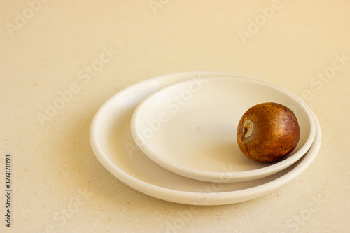 Bone from the avocado or avocado seed on beige ceramic plates.