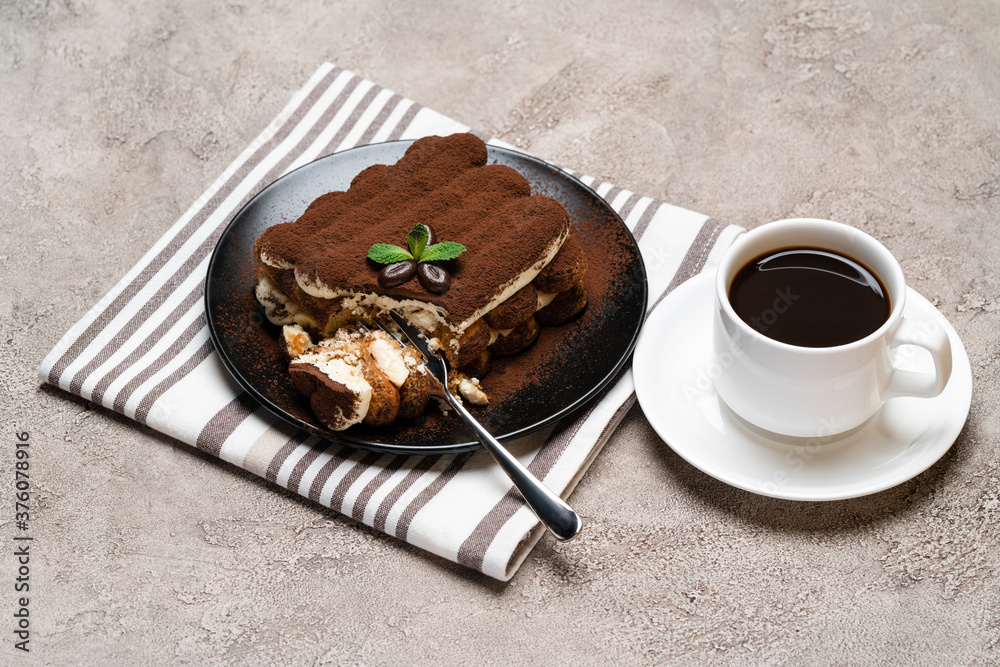 portion of Classic tiramisu dessert and cup of fresh espresso coffee on concrete background portion of Classic tiramisu dessert and cup of fresh espresso coffee on concrete background