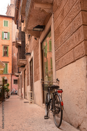 Near the entrance to the old house, in the old quarter of the city, there is a bicycle near the wall.