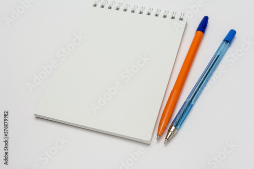 empty school notebook and pens on a white background