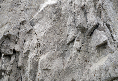 A fragment of limestone rock with large protrusions and cracks.