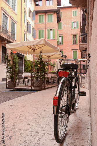 Near the entrance to the old house, in the old quarter of the city, there is a bicycle near the wall. © Serhii