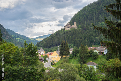 Scenic view of a valley with the small town of Ramingstein, Austria. Historic castle (burg) Finstergrun is located on a mountain slope above the town. photo