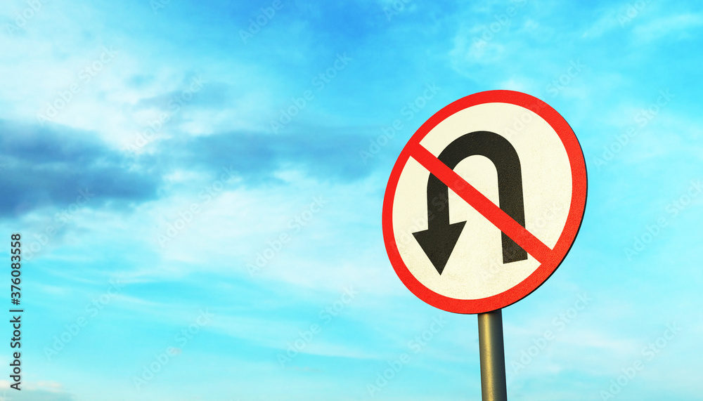 No U-Turn road sign on a metal pole against the blue sky