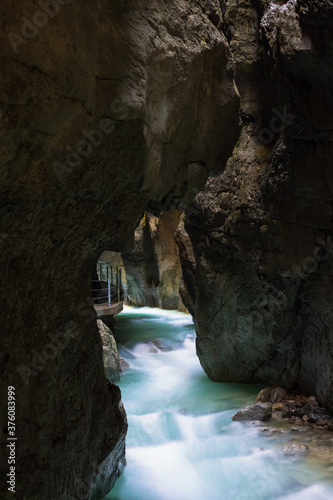 Clean, beautiful, mountain river flows through a rocky grot Partnachklamm in Germany incised by a mountain stream near the Garmisch-Partenkirchen.