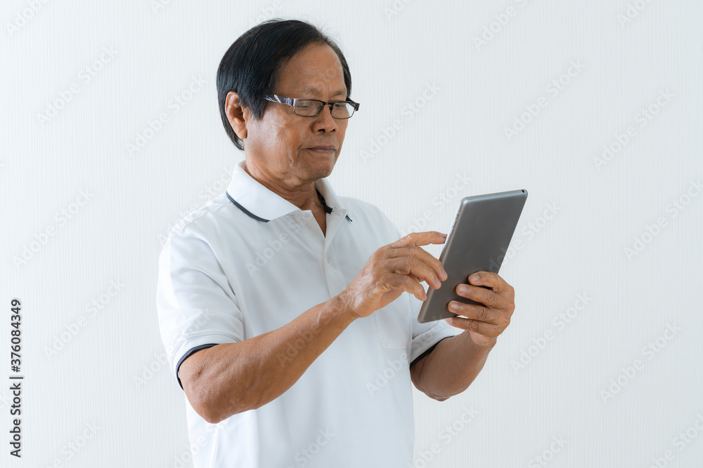 Portrait of Asian senior man using a digital tablet Portrait of Asian senior man using a digital tablet