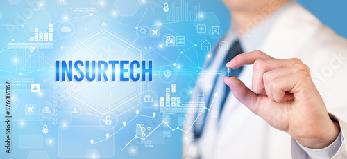 Doctor giving a pill with INSURTECH inscription, new technology solution concept