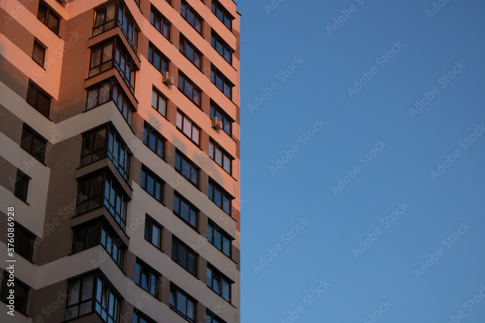 Facade of a modern light building on a blue sky background Facade of a modern light building on a blue sky background