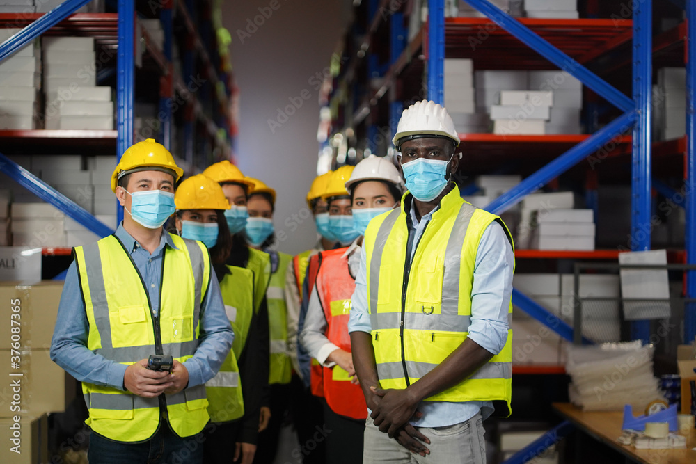 Warehouse manager, working team to wear a face to prevent COVID 19. Team Cooperative Organization Warehouse manager, working team to wear a face to prevent COVID 19. Team Cooperative Organization