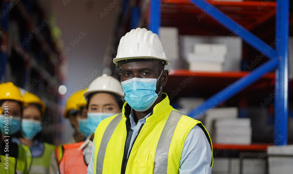 Warehouse manager, working team to wear a face to prevent COVID 19. Team Cooperative Organization Warehouse manager, working team to wear a face to prevent COVID 19. Team Cooperative Organization