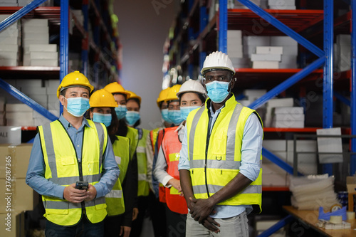 Warehouse manager, working team to wear a face to prevent COVID 19. Team Cooperative Organization