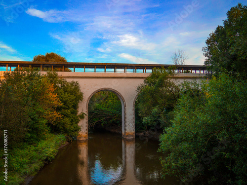 The old bridge crosses the river at sunset