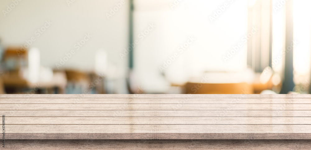 Empty wooden table top with lights bokeh on blur restaurant background Empty wooden table top with lights bokeh on blur restaurant background
