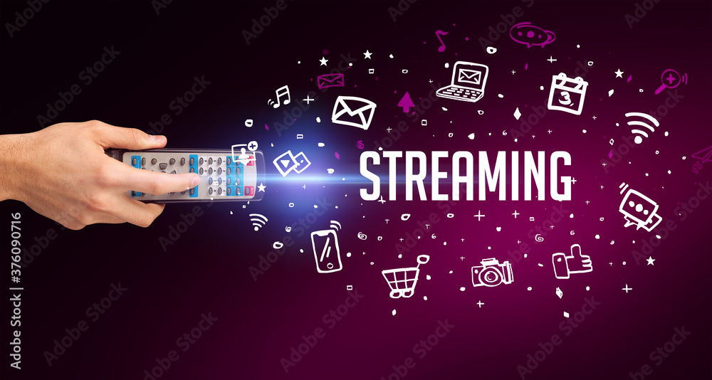hand holding wireless peripheral with STREAMING inscription, social media concept hand holding wireless peripheral with STREAMING inscription, social media concept