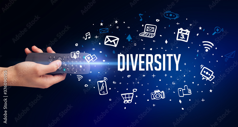 hand holding wireless peripheral with DIVERSITY inscription, social media concept hand holding wireless peripheral with DIVERSITY inscription, social media concept