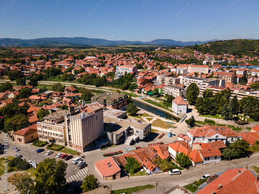 Top aerial view from drone on the buildings and houses in the city with river in sunny summer or autumn day - Knjazevac town in east Serbia cityscape