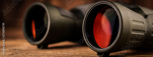 Banner army binocular on wooden table. Travel concept.