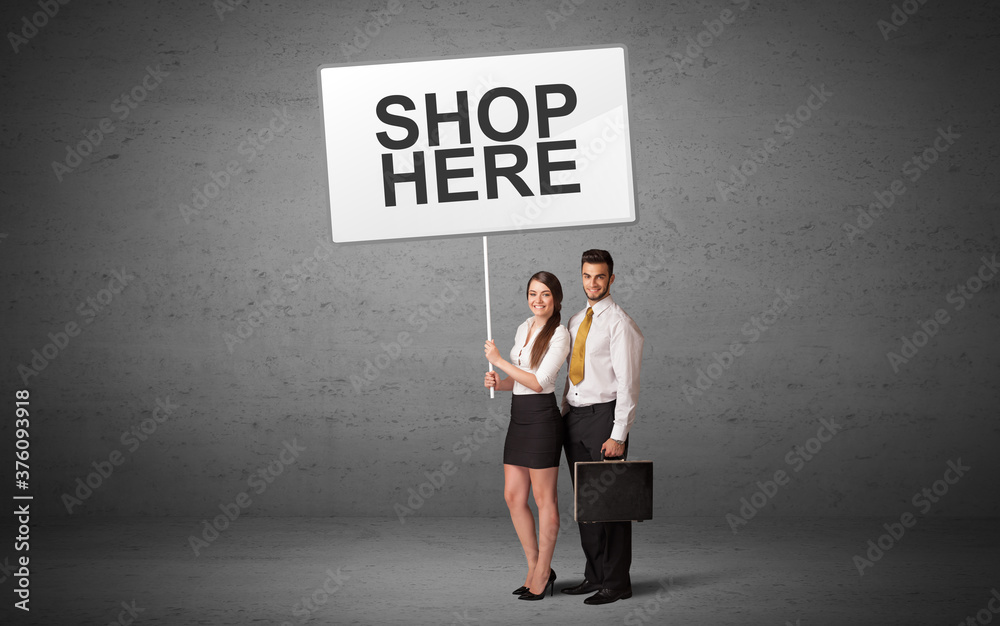 business person holding a traffic sign with SHOP HERE inscription, new idea concept business person holding a traffic sign with SHOP HERE inscription, new idea concept