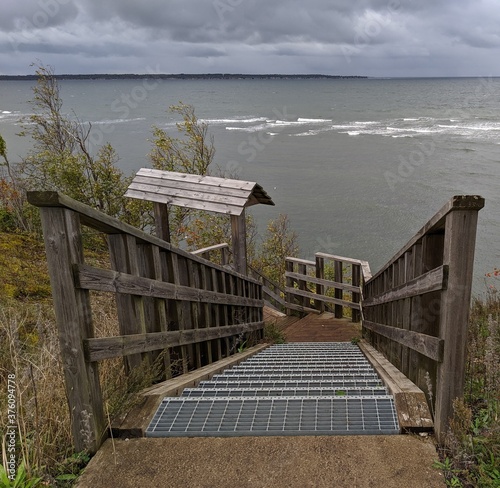 Wooden stairs  from the cliff to the rough sea 