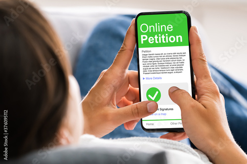 Canvas Print Holding Mobile Phone To Sign Petition