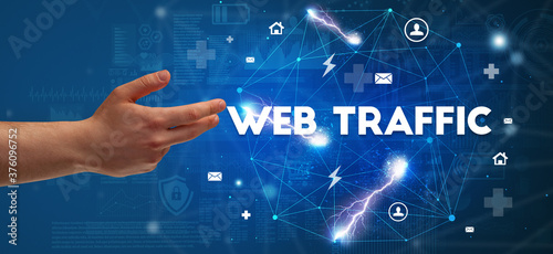 Hand pointing at WEB TRAFFIC inscription, modern technology concept