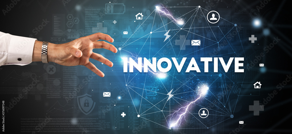 Hand pointing at INNOVATIVE inscription, modern technology concept Hand pointing at INNOVATIVE inscription, modern technology concept