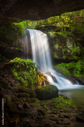 Amazing beauty of scenic waterfall called Skok (The Jump) in village on Old mountain called Senokos, framed by rocks and surrounded by sunlit green plants