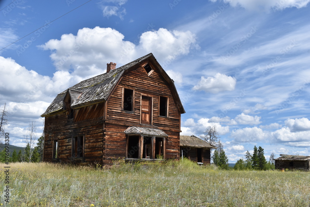 Old abandoned wooden house or barn. Empty, broken windows. Old abandoned wooden house or barn. Empty, broken windows.