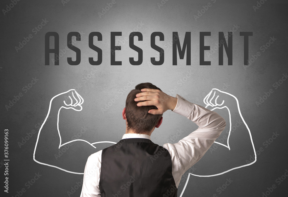 Rear view of a businessman with ASSESSMENT inscription, powerfull business concept