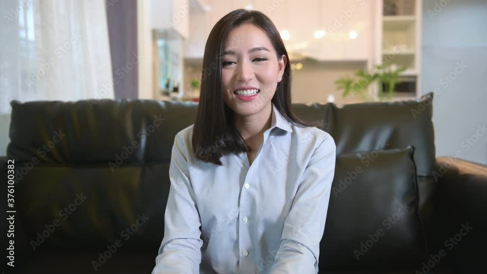 Headshot screen view of  young asian woman is using laptop computer to Video calling or Webcam to greeting her family , telecommunications technology , parenthood family concept