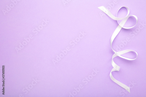 Purple ribbon on purple pastel background, design element.