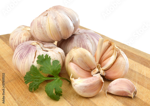 raw garlic on a wooden plank