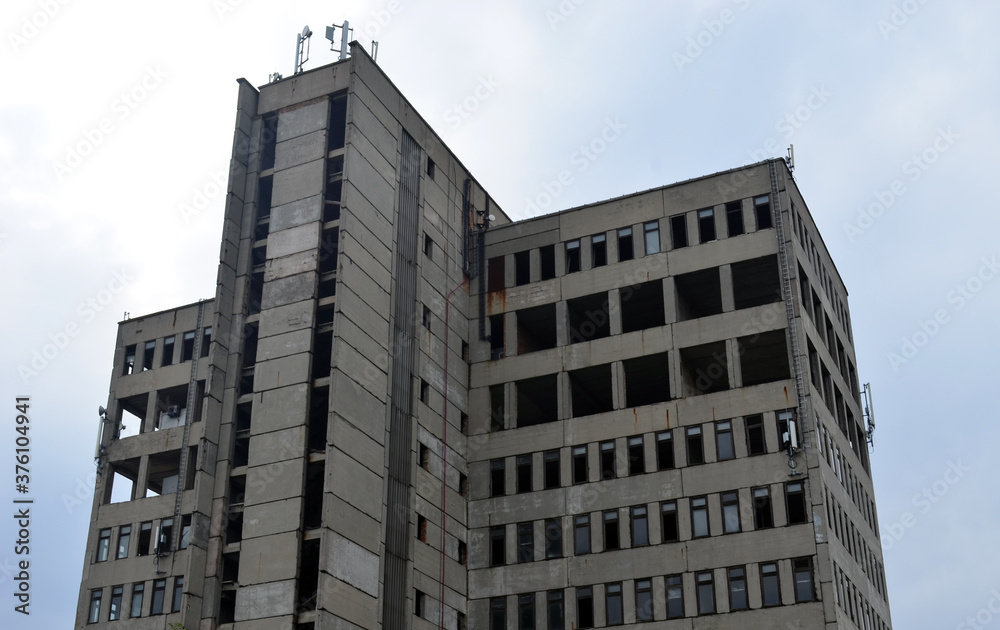 Fototapeta premium Abandoned residential building. An old high-rise building.