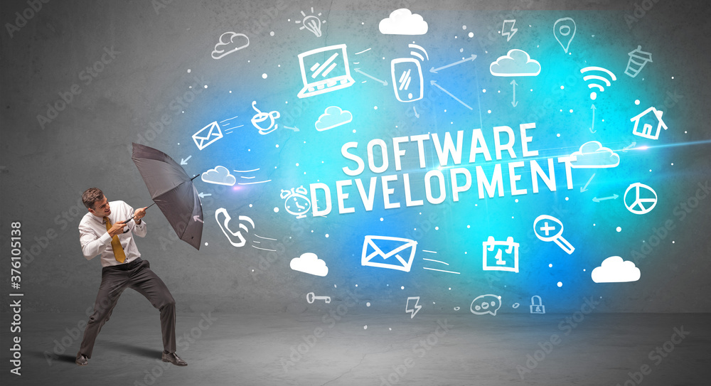 Businessman defending with umbrella from SOFTWARE DEVELOPMENT inscription, modern technology concept Businessman defending with umbrella from SOFTWARE DEVELOPMENT inscription, modern technology concept