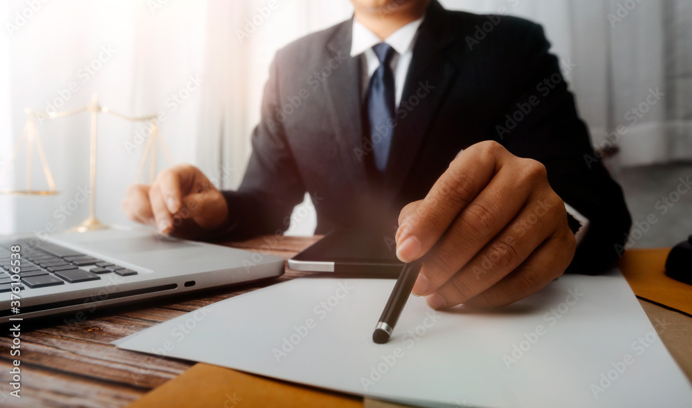 Business and lawyers discussing contract papers with brass scale on desk in office. Law, legal services, advice, justice and law concept picture with film grain effect