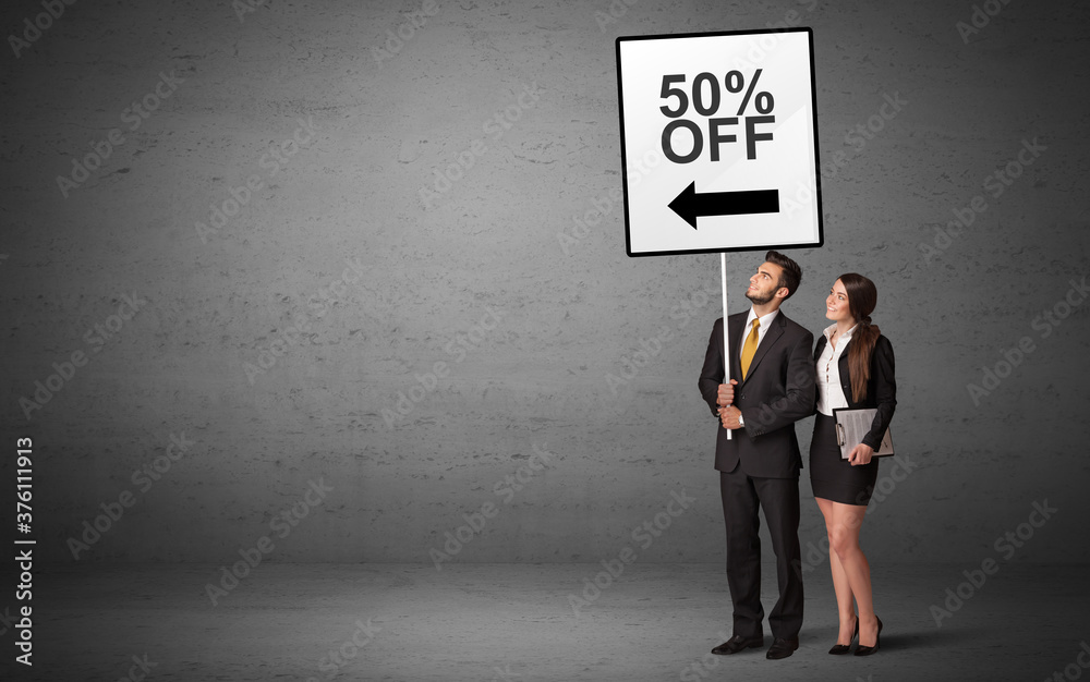 business person holding a traffic sign with 50% OFF inscription, new idea concept business person holding a traffic sign with 50% OFF inscription, new idea concept