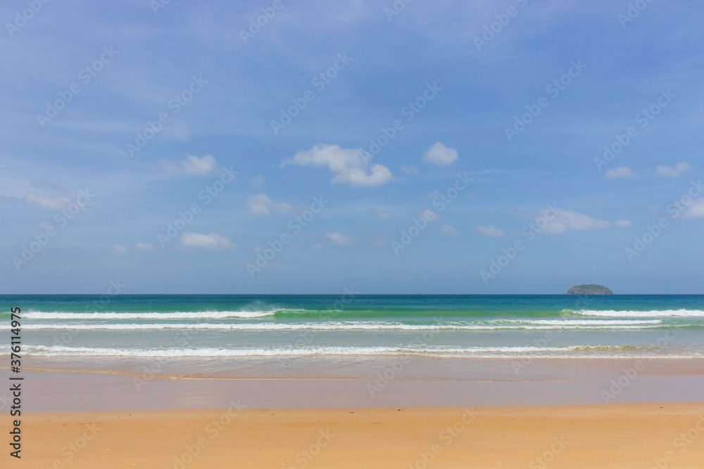 Empty tropical beach on sunny day. Duli beach in Palawan, Philippines. Surf beach. Wide beach with island on background. Travel in Asia. Tropical landscape. Azure water in idyllic lagoon. 