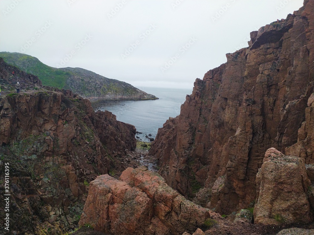 High cliffs and waterfalls on the Barents sea coast of the Arctic ocean