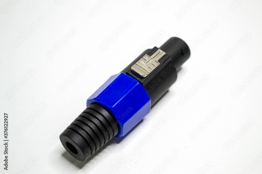 Studio audio or instrument cable extending isolated on a white background. Shot of microphone studio connector closeup. Studio audio or instrument cable extending isolated on a white background. Shot of microphone studio connector closeup.