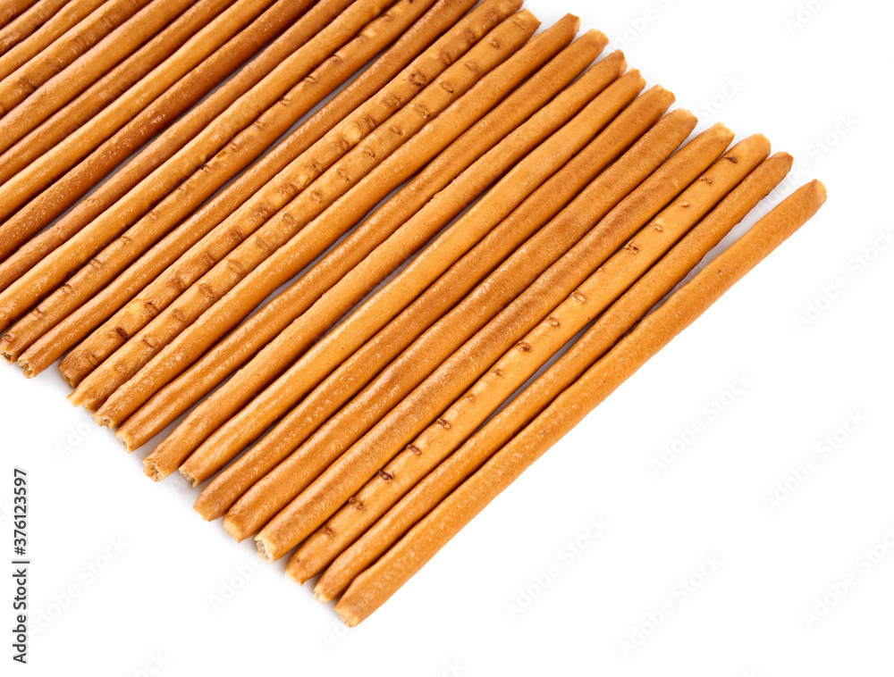 Creative layout made of crackers sticks on the white background. Food concept. Edible snack dry sticks with salt on white background. Straws, sticks crackers. Creative layout made of crackers sticks on the white background. Food concept. Edible snack dry sticks with salt on white background. Straws, sticks crackers.