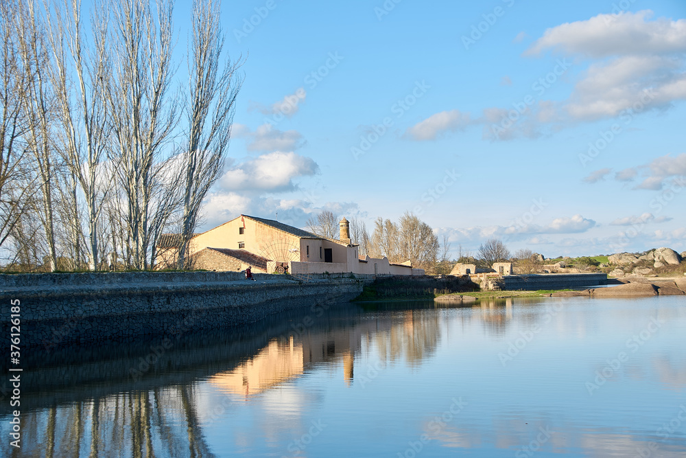 Fototapeta premium old house in front of a lake