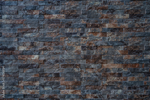Texture of black with brown brick stone wall