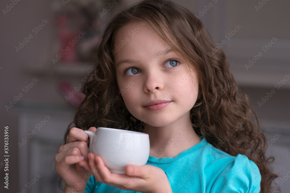 cute little girl sitting by dinner table and eating cute little girl sitting by dinner table and eating