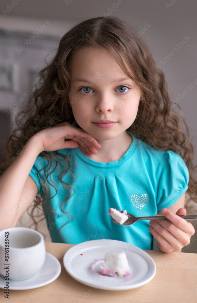 cute little girl sitting by dinner table and eating cute little girl sitting by dinner table and eating