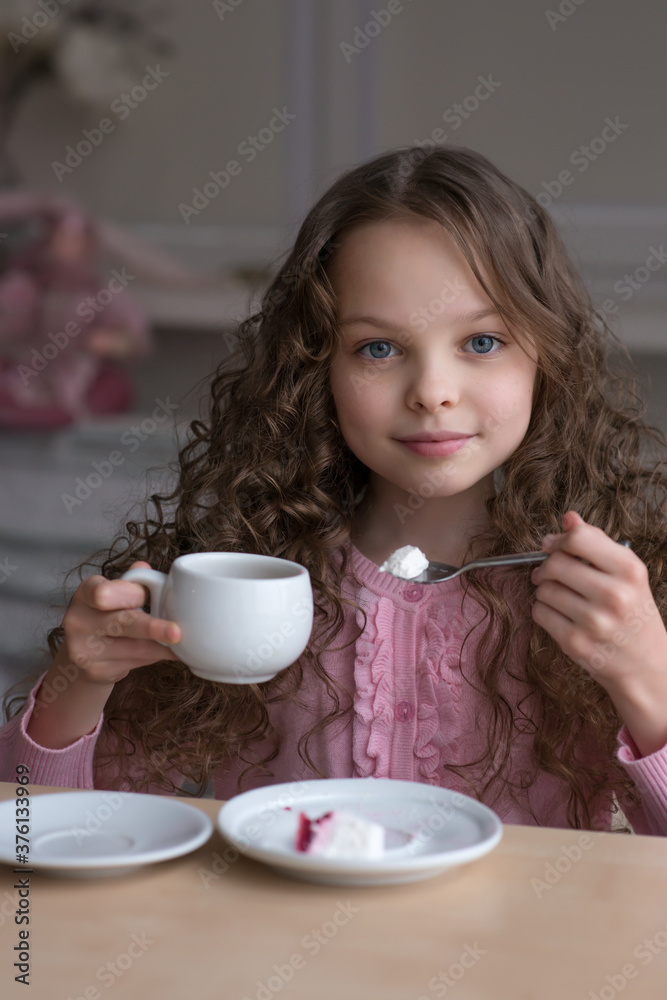 cute little girl sitting by dinner table and eating cute little girl sitting by dinner table and eating